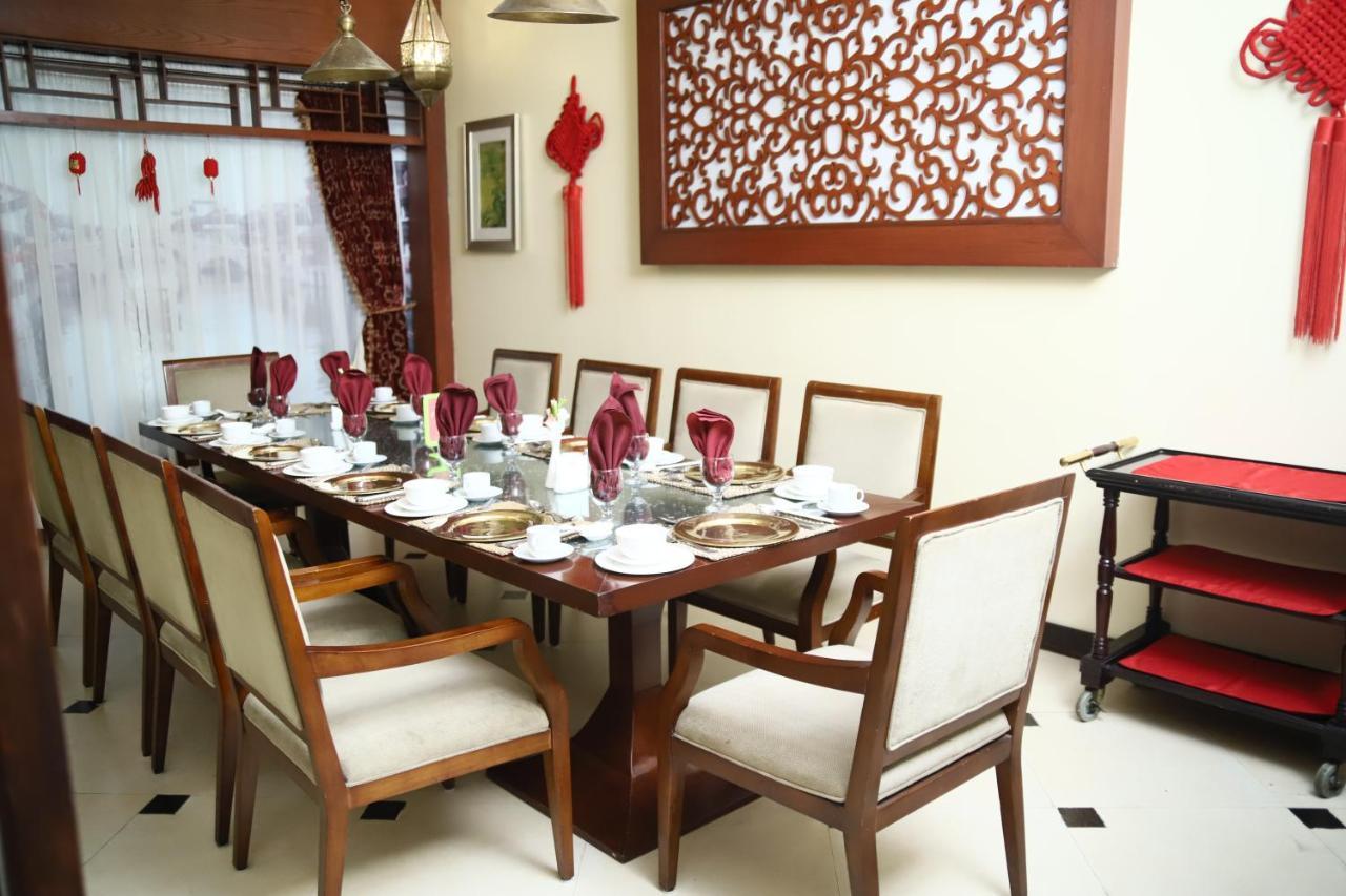 Ramada Plaza By Wyndham Karachi Airport Hotel Екстериор снимка A dining room in a house in Malaysia